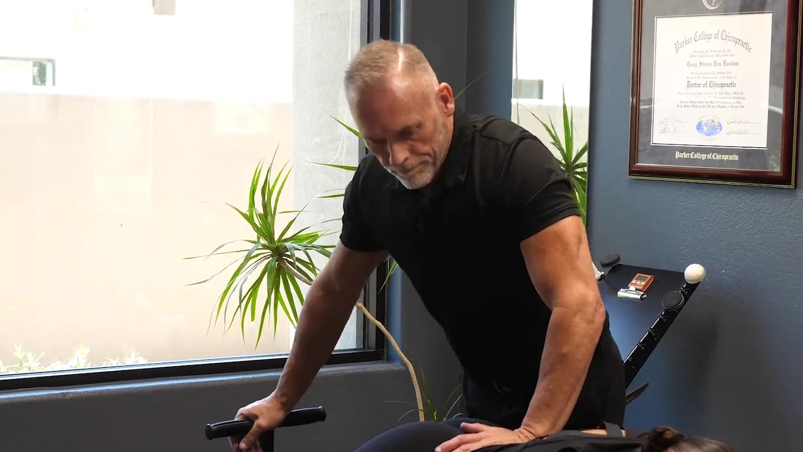 Dr. Steve Van Laecken DC adjusting a patient lying face down on a treatment table at SpinalWorks Chiropractic