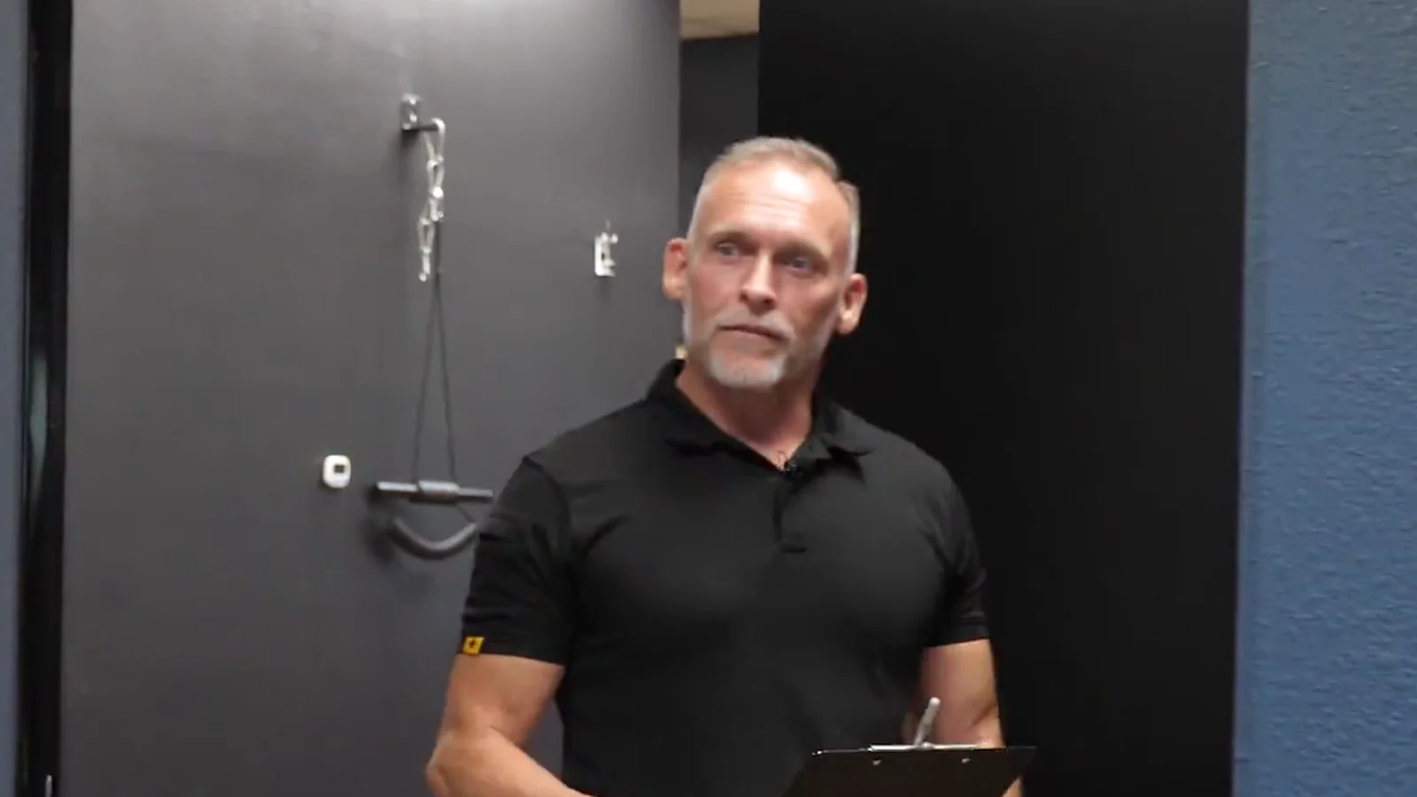 Dr. Steve Van Laecken DC walking down a hallway at SpinalWorks Chiropractic with a clipboard