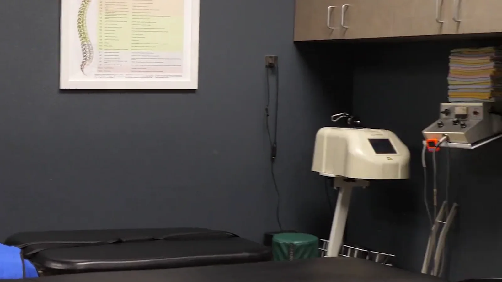 A treatment room at SpinalWorks Chiropractic with treatment tables and therapy equipment